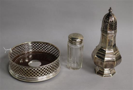 A modern silver wine coaster, a modern silver sugar caster and a silver mounted toilet bottle.